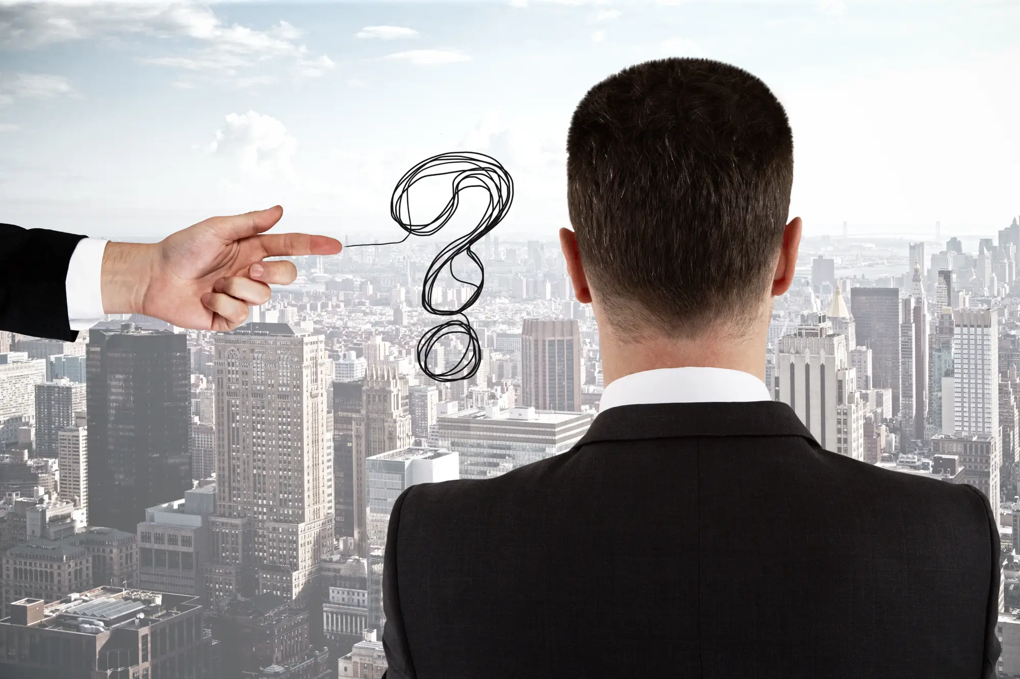 Man looking at a question mark drawn in the sky over a city